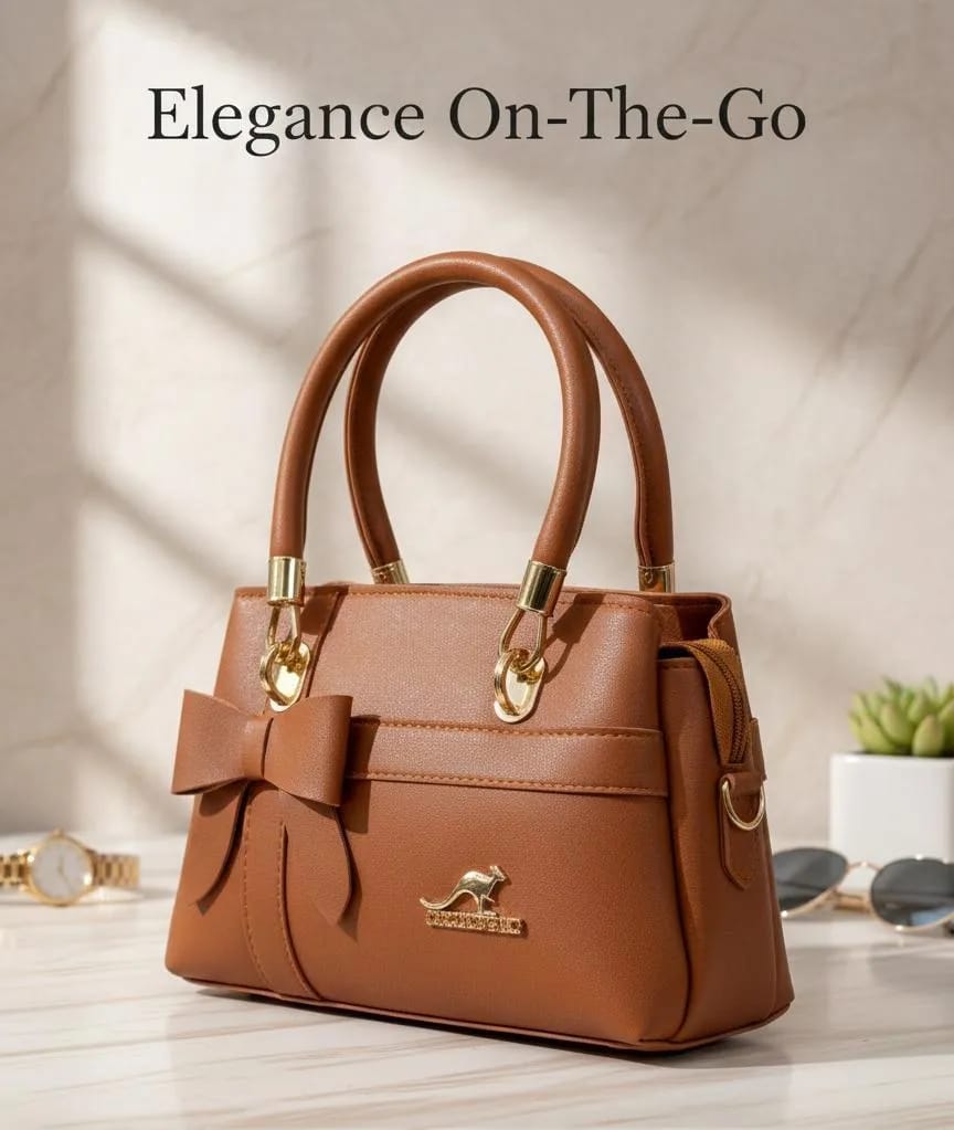 The Bow Satchel in Caramel — front view with bow detail and gold hardware