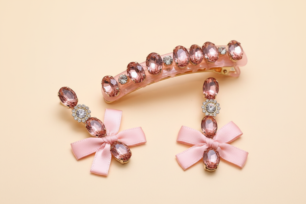 Close-up of pink faceted embellished hair clip and matching bow drop earrings