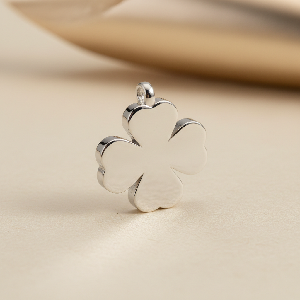 Close-up of a silver four-leaf clover pendant