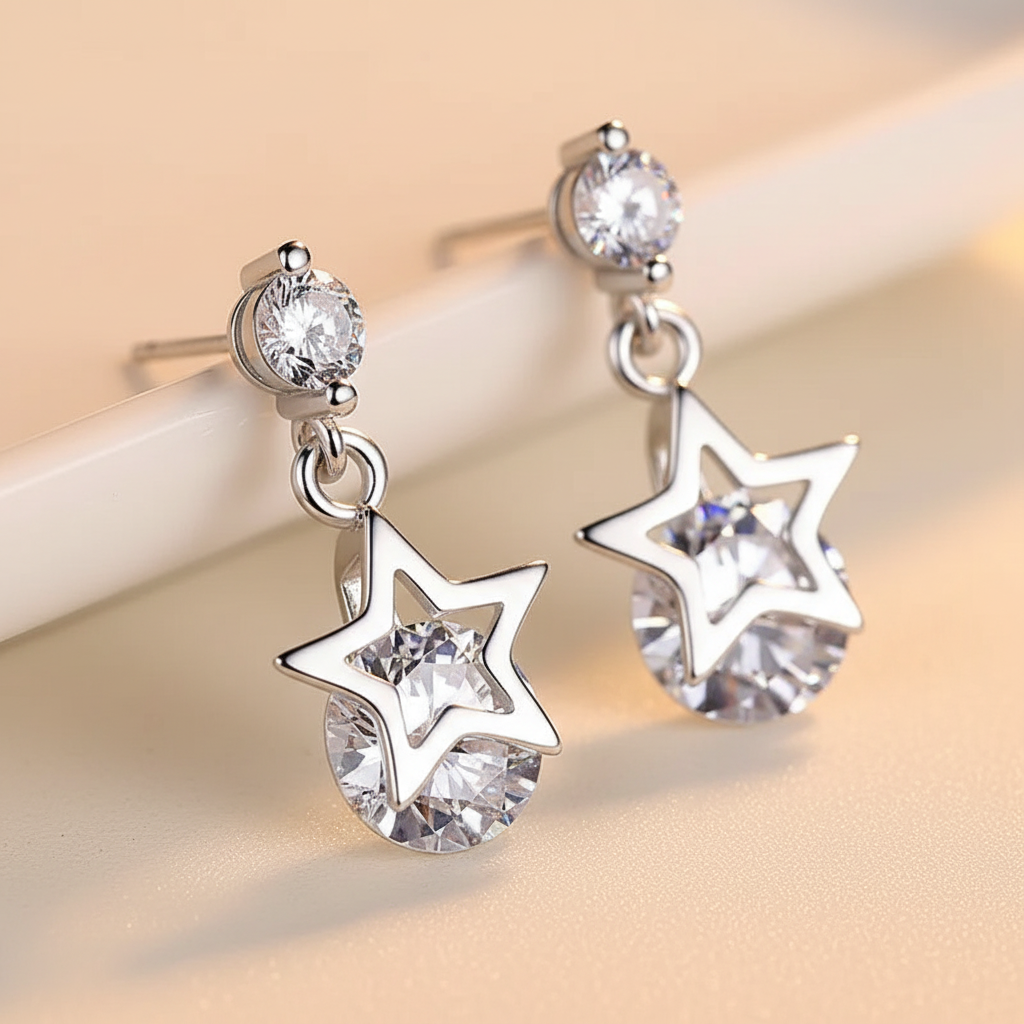 Close detail of silver-tone star crystal drop earrings with faceted clear stones