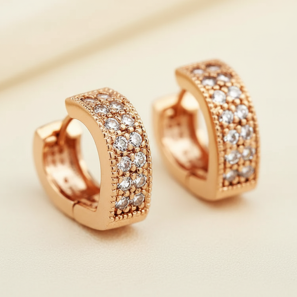 Close detail of rose gold pavé zircon huggie hoop earrings
