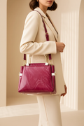 Woman carrying a maroon printed leather shoulder bag