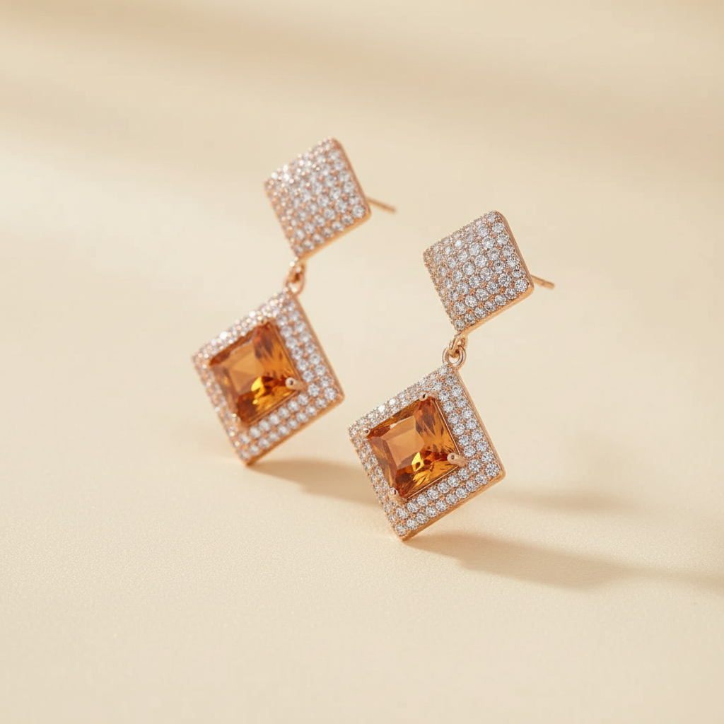 Close detail of golden crystal diamond-shape drop earrings
