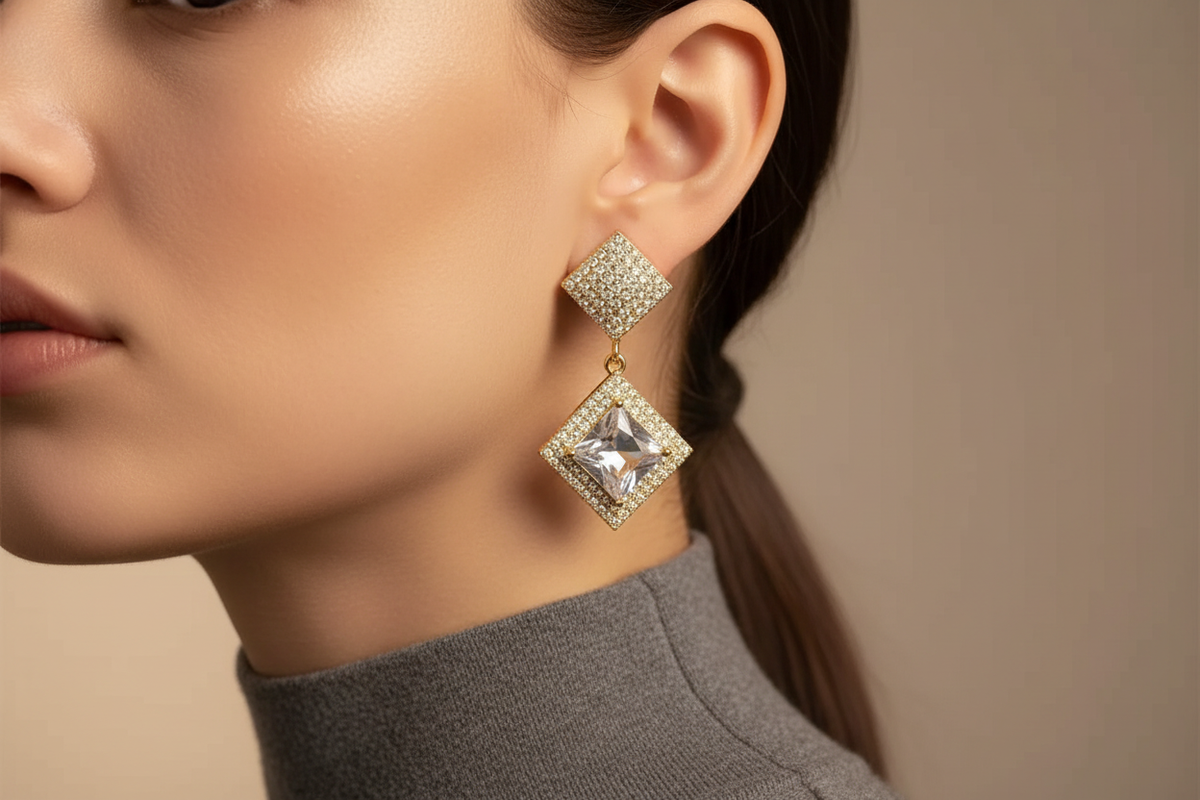 Gold-plated crystal geometric earring worn in a refined close-up editorial portrait
