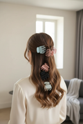 Woman wearing multicolor claw hair clips in a half-up hairstyle