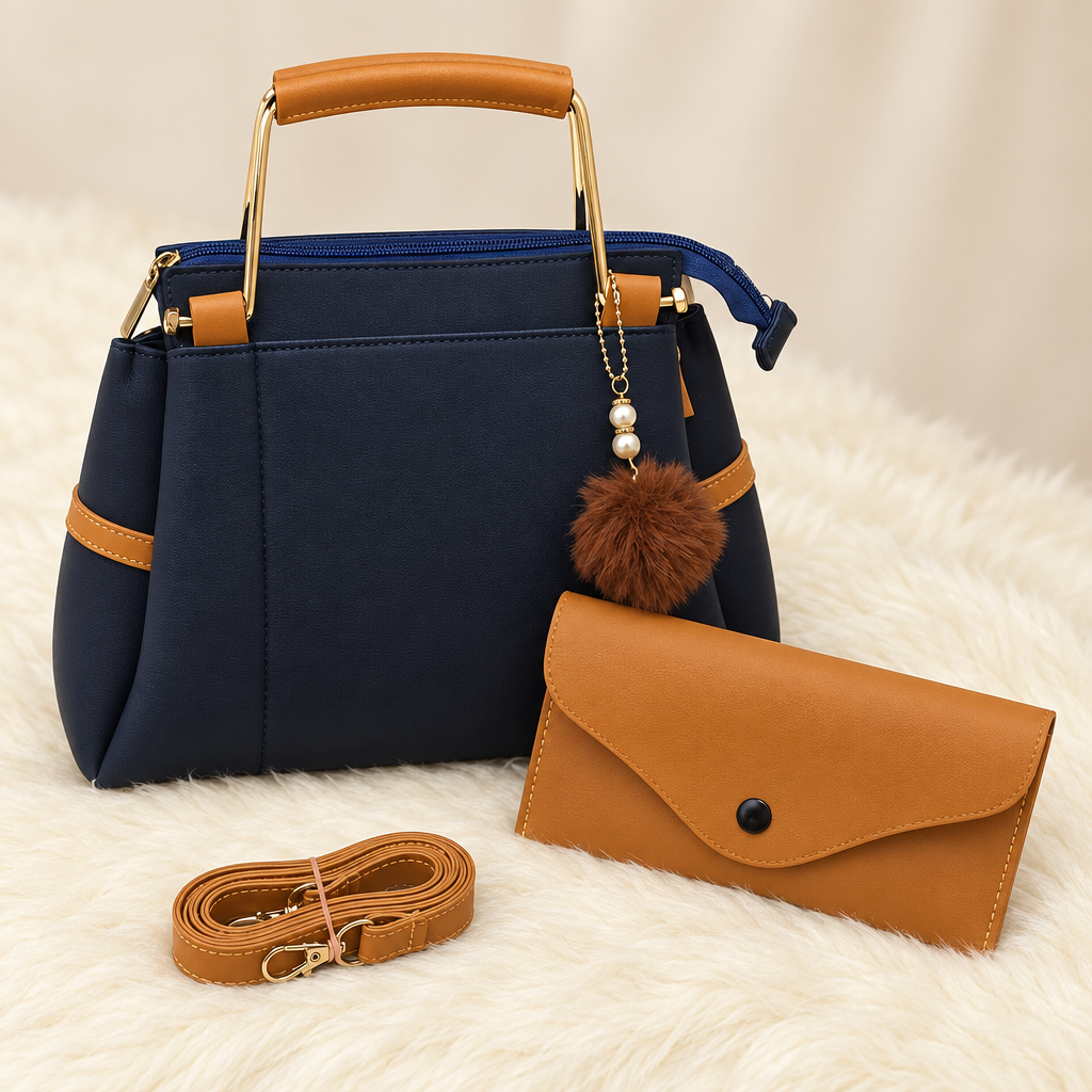 Close view of navy handbag gold-tone handle tan pouch and detachable tan strap
