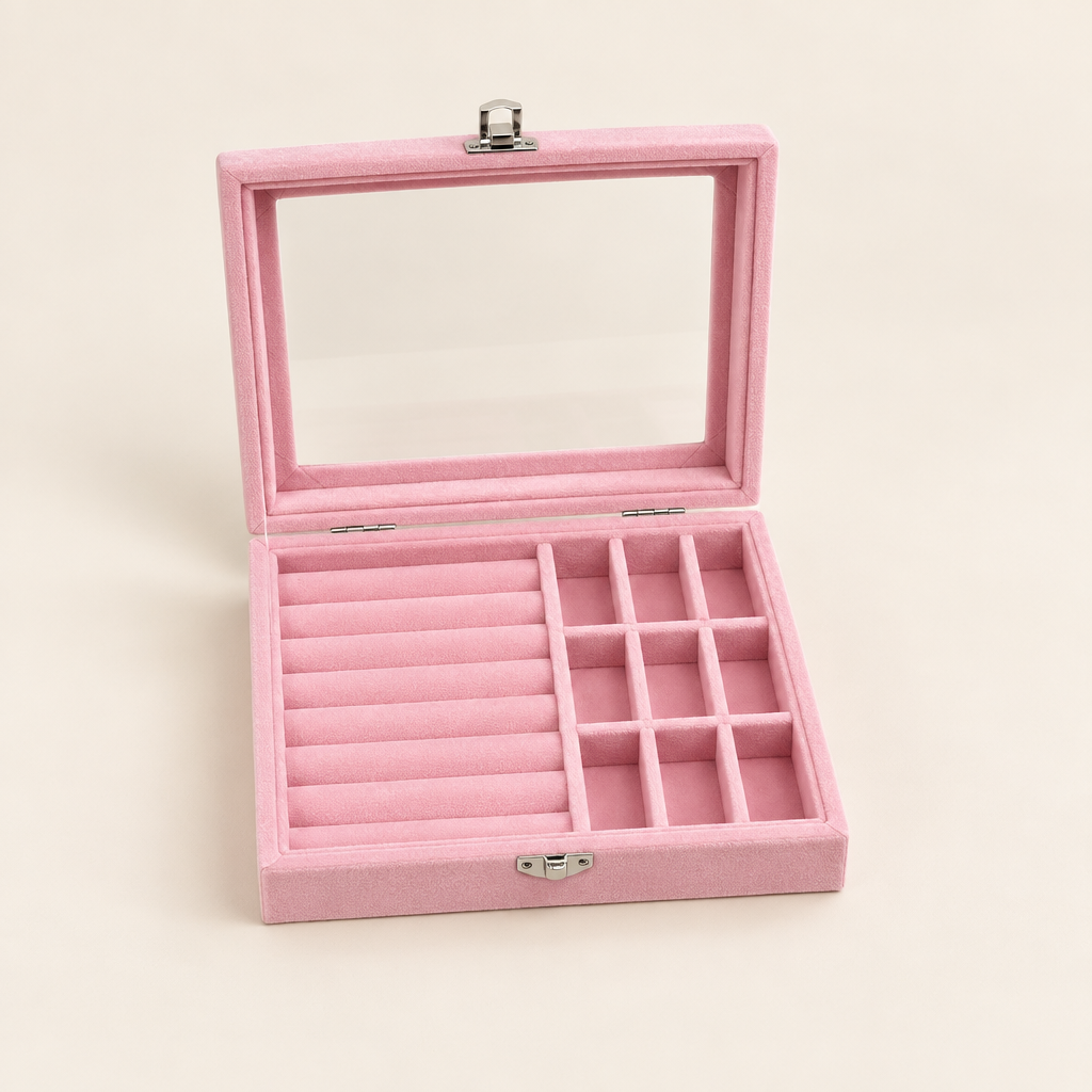 Open pink jewelry organizer box with clear lid and divided compartments on ivory background