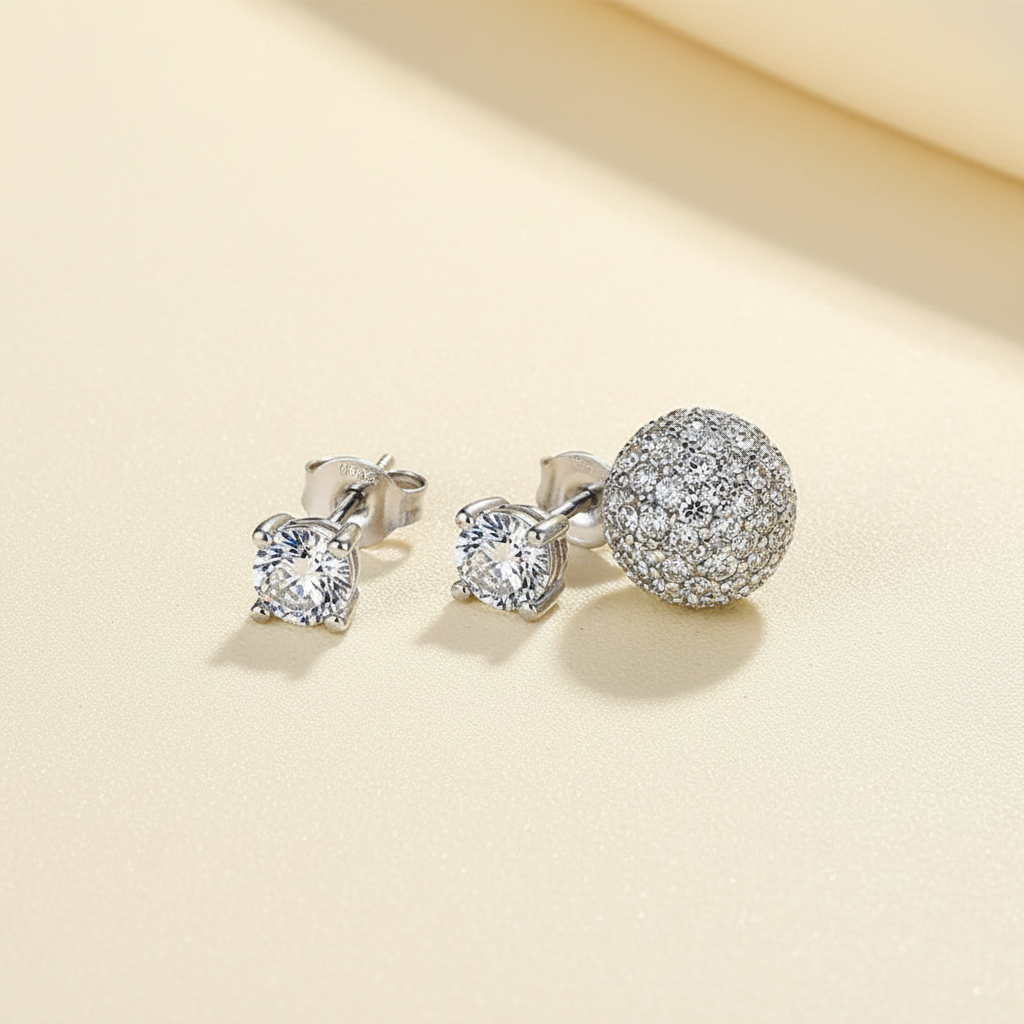 Four-claw zircon stud earrings with matching ear plugs on a warm ivory background