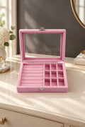 Pink jewelry organizer box open on an elegant dressing table