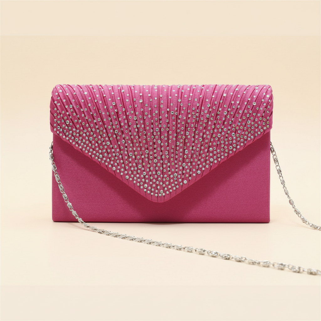Close detail of a pink satin clutch with pleated rhinestone flap and silver chain