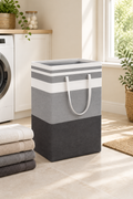 Grey and white striped laundry basket beside folded towels in a bright laundry room