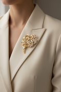 Pearl floral bouquet brooch styled on the lapel of a cream blazer
