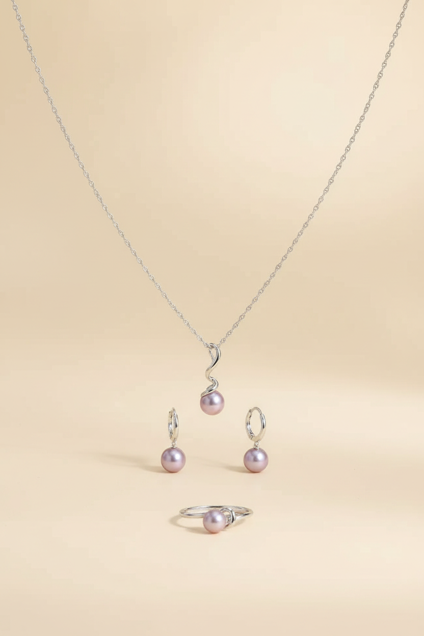 Purple pearl 925 silver necklace, earrings and ring jewellery set on a warm ivory background