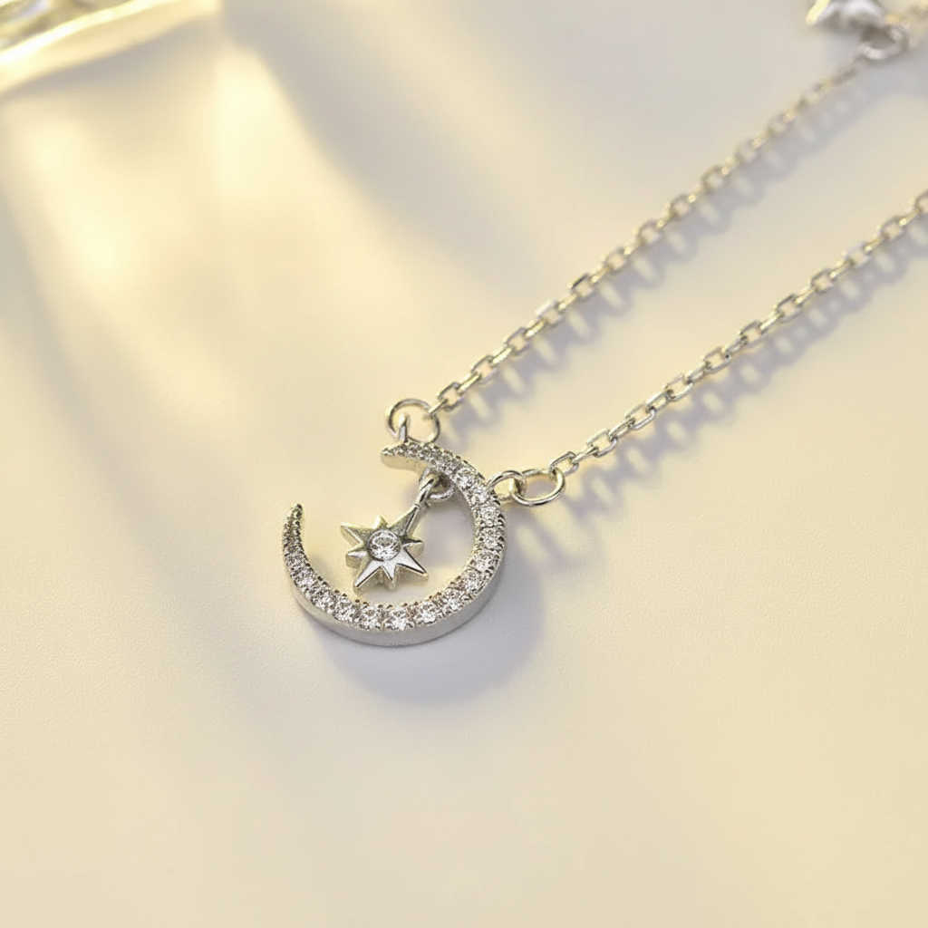 Close-up of pavé crescent moon pendant with star in sterling silver
