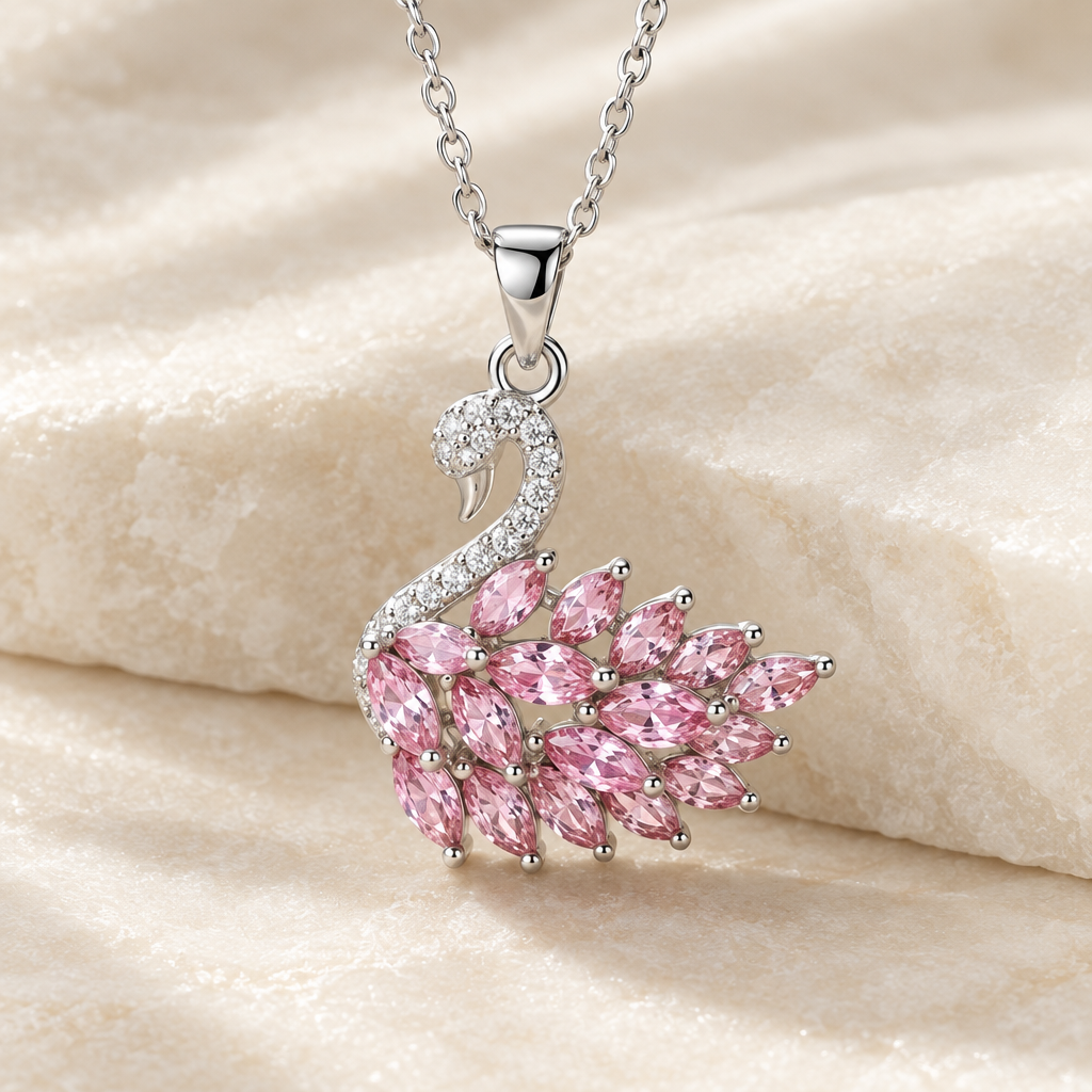 Close-up of silver-tone swan pendant with pink stone wing
