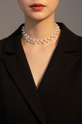 White beaded choker necklace styled with a black blazer