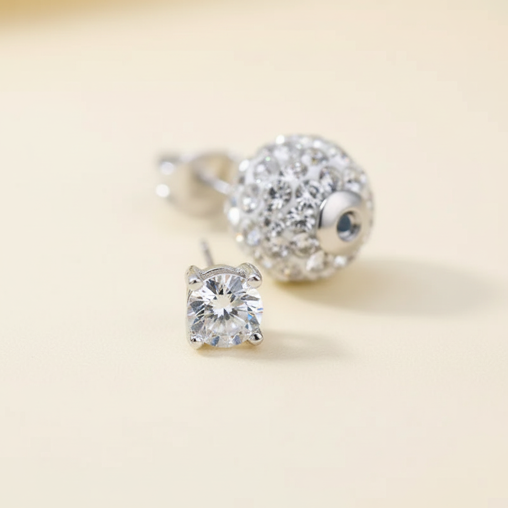 Close detail of a four-claw zircon stud earring and matching ear plug