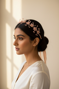 Model wearing a peach floral crown hairband with an ivory outfit