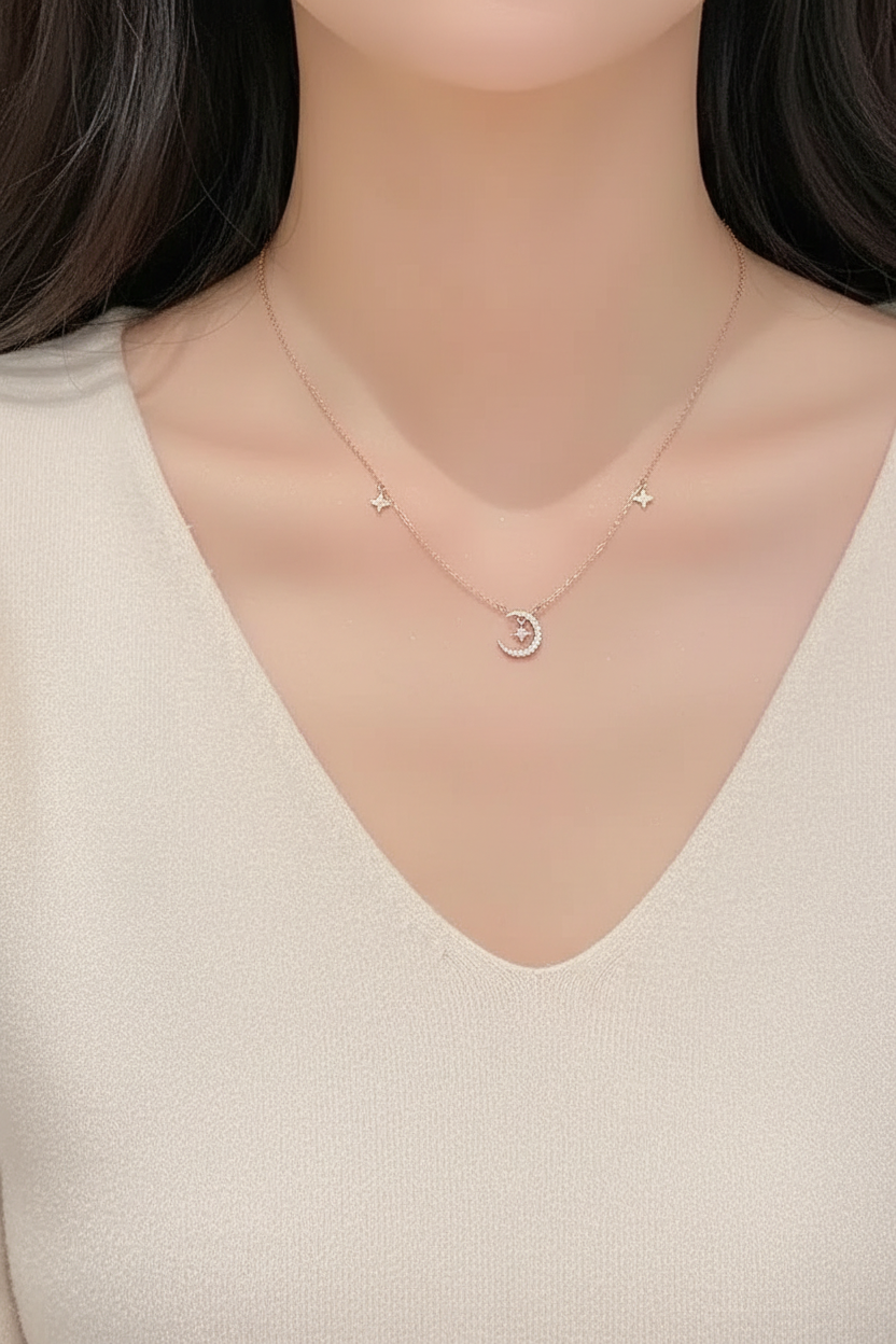 Woman wearing a delicate rose gold star and moon clavicle necklace