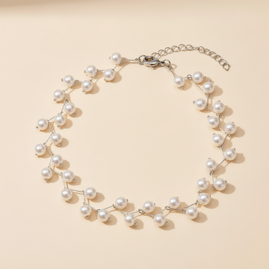 White beaded choker necklace arranged on a warm ivory background