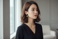 Woman wearing black and gold geometric square earrings with a black outfit