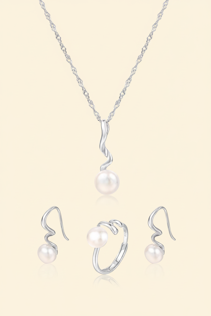 White pearl 925 silver necklace, earrings and ring jewellery set on a warm ivory background